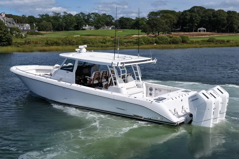Slide: The Image of 2026 Everglades 455 Center Console boat cruising on a scenic waterway. - 10