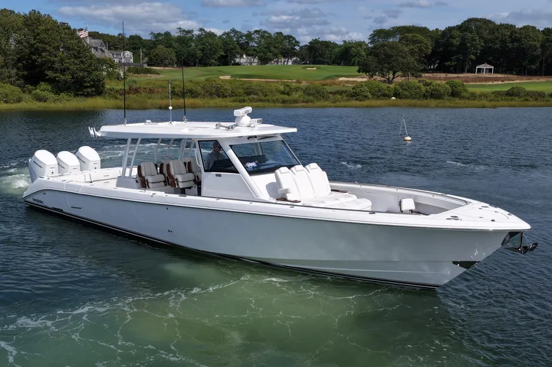 Slide: The Image of 2026 Everglades 455 Center Console boat cruising on a scenic waterway. - 4