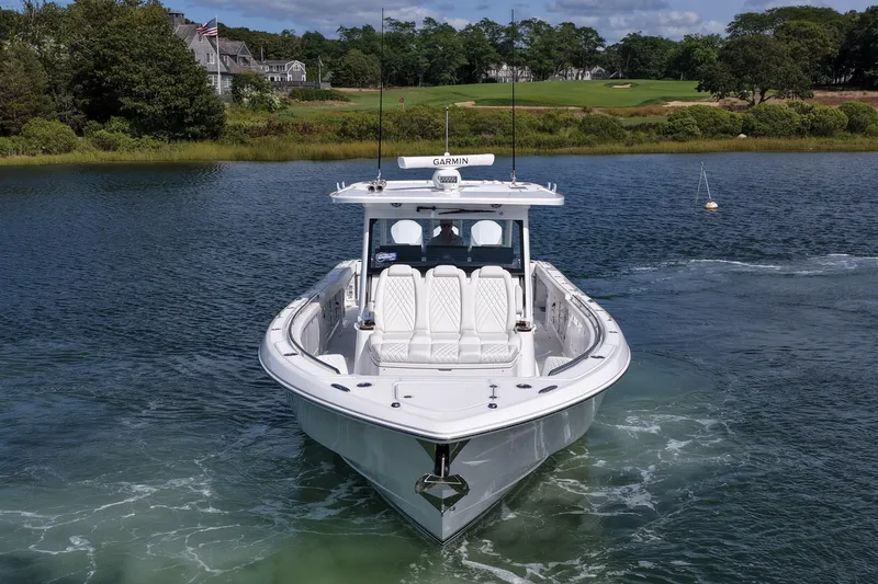 Slide: The Image of 2026 Everglades 455 Center Console boat on serene water, surrounded by lush greenery. - 2