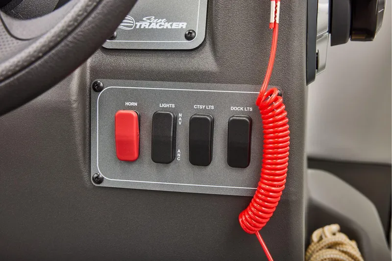 Slide: The Image of Manufacturer Provided Image: Control panel of 2026 Sun Tracker Party Barge 16 DLX with switches and coiled cord. - 23