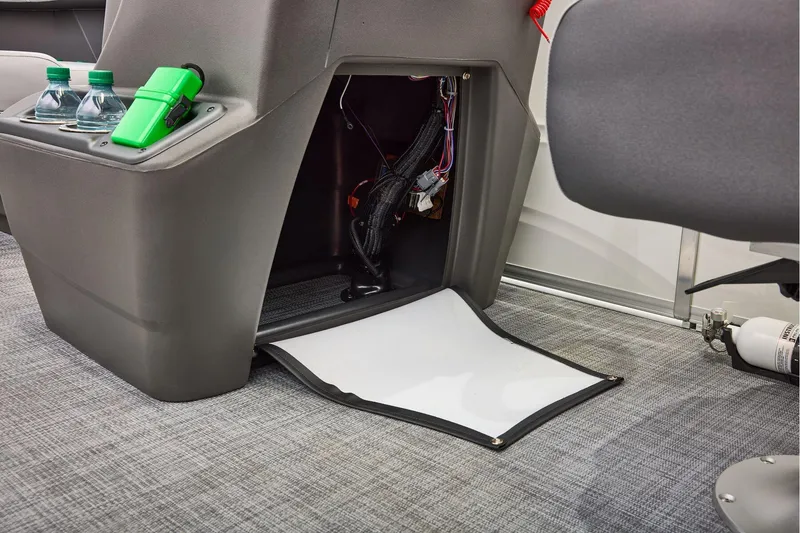 Slide: The Image of Manufacturer Provided Image: Interior of 2026 Sun Tracker Party Barge 16 DLX with storage compartment and cup holders. - 24