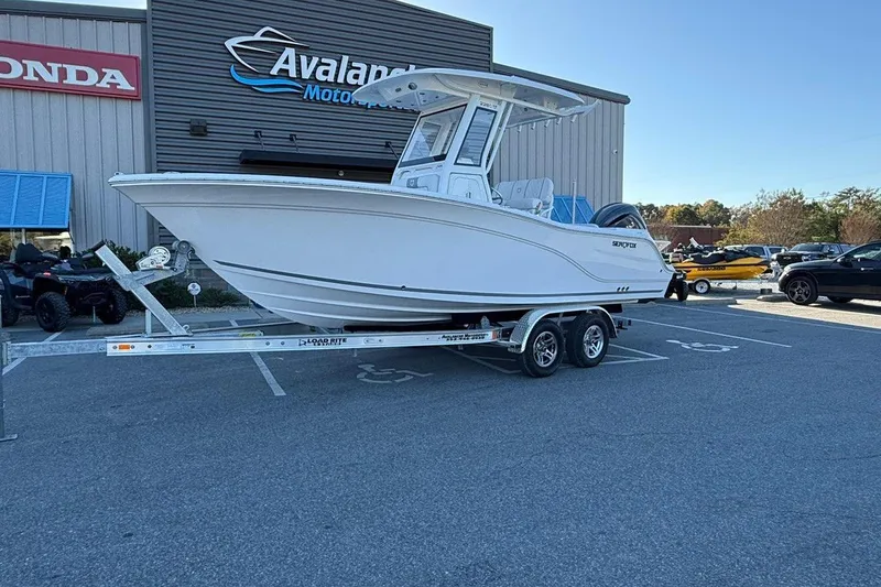The Image of 2026 Sea Fox 228 Commander boat on trailer at dealership parking lot. - 0