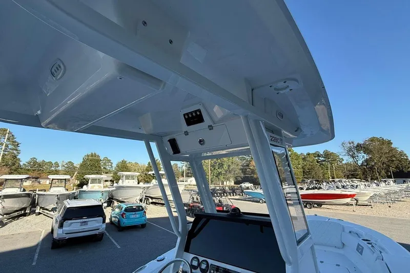 Slide: The Image of 2026 Sea Fox 228 Commander boat interior with console, parked in a marina. - 10