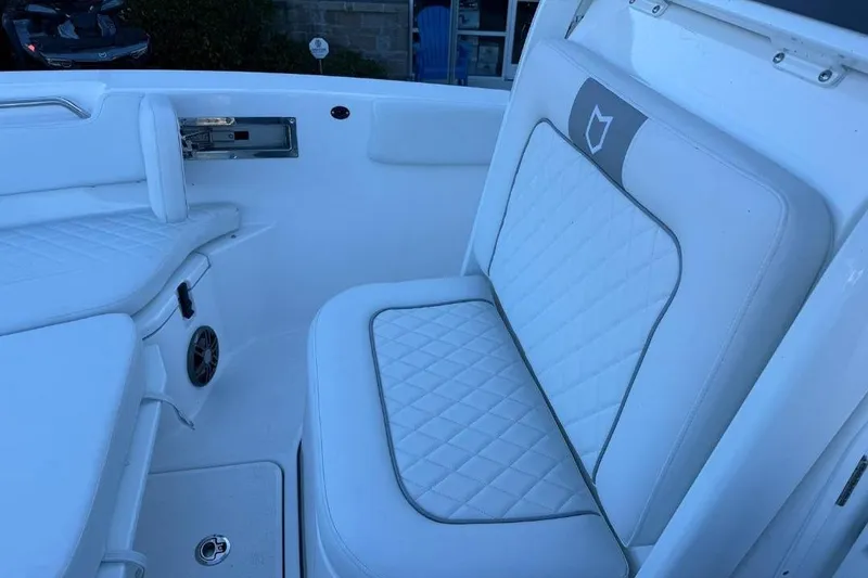 Slide: The Image of 2026 Sea Fox 228 Commander boat interior with white cushioned seating. - 12