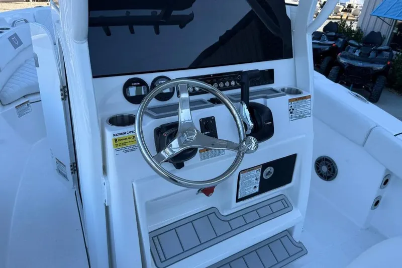 Slide: The Image of 2026 Sea Fox 228 Commander boat dashboard with steering wheel and controls. - 13