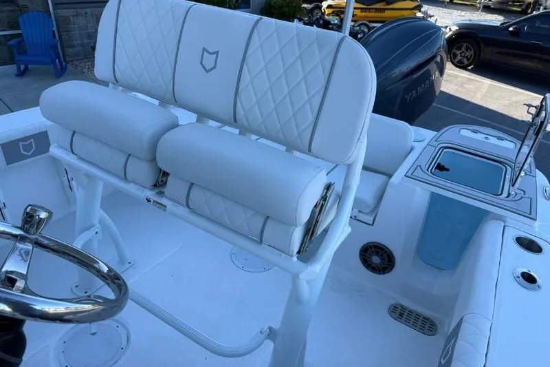 Slide: The Image of 2026 Sea Fox 228 Commander boat interior with white cushioned seating and steering wheel. - 14