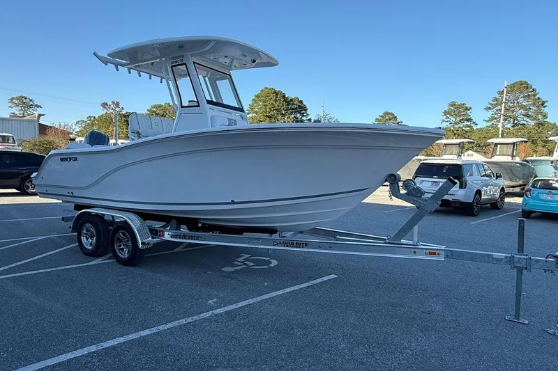 Slide: The Image of 2026 Sea Fox 228 Commander boat on trailer in parking lot, clear sky background. - 3