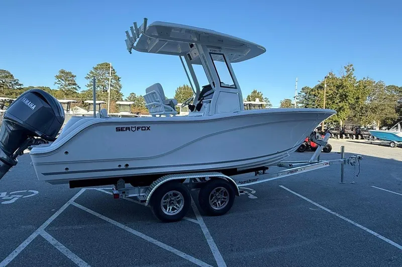 Slide: The Image of 2026 Sea Fox 228 Commander boat on trailer in parking lot, clear sky background. - 6