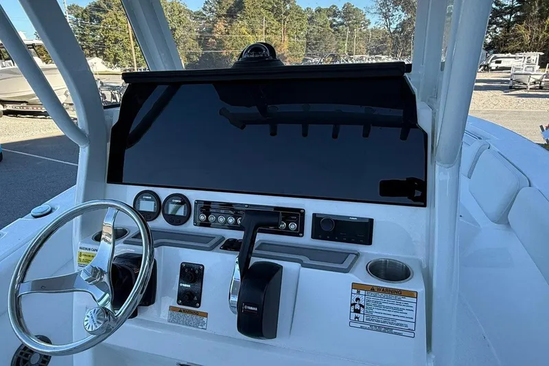 Slide: The Image of 2026 Sea Fox 228 Commander boat dashboard with steering wheel and controls. - 9