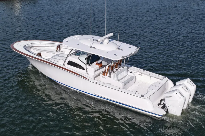 Slide: The Image of 2026 Mag Bay 38 boat cruising on water, featuring sleek design and twin Mercury engines. - 13