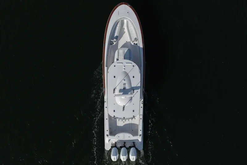 Slide: The Image of Aerial view of 2026 Mag Bay 38 boat cruising on dark water. - 16