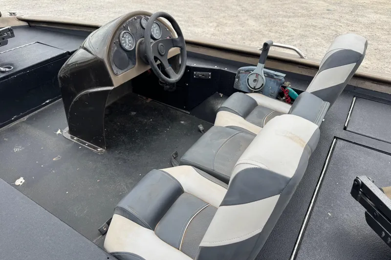Slide: The Image of Interior of a 2000 Express X51 boat with steering wheel and seats. - 7