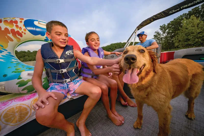 Slide: The Image of Manufacturer Provided Image: Family enjoying a boat ride with a dog on a 2026 Sun Tracker Party Barge 18 DLX. - 11