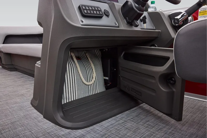 Slide: The Image of Manufacturer Provided Image: 2026 Sun Tracker Party Barge 18 DLX interior storage compartment with striped bag. - 43