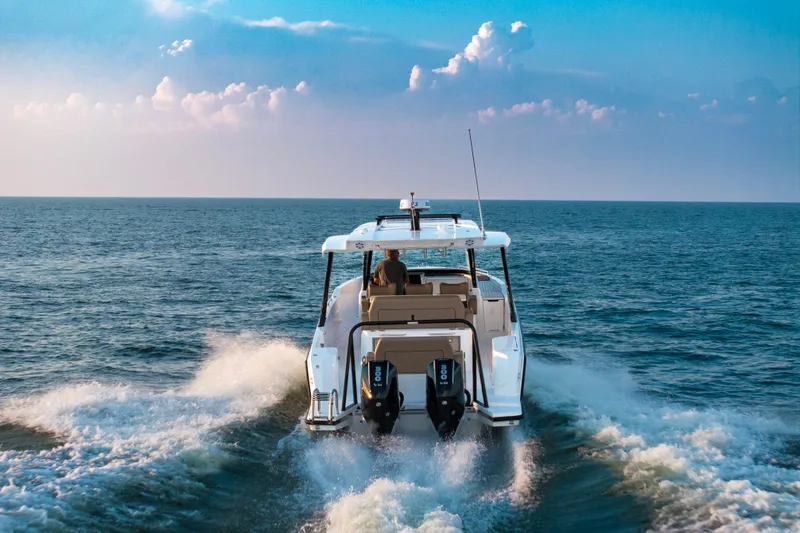 Slide: The Image of 2026 Cruisers Yachts 38 VTR on serene water, showcasing spacious deck and modern design. - 3