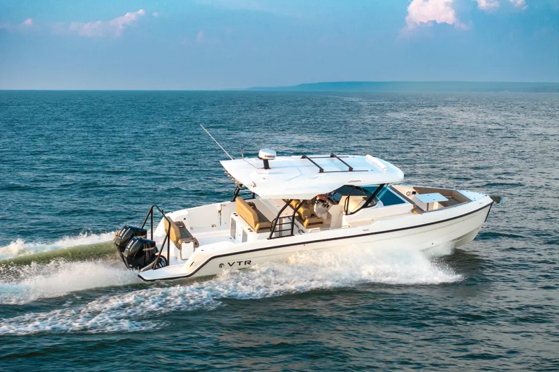 Slide: The Image of 2026 Cruisers Yachts 38 VTR boat deck with seating, overlooking serene ocean view. - 4