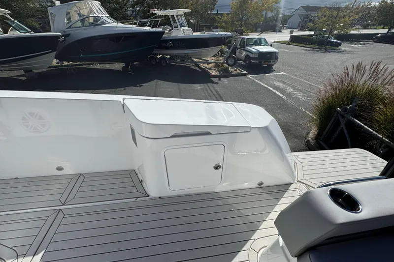 Slide: The Image of 2026 Cruisers Yachts 38 VTR boat deck with storage compartment and sleek design. - 11