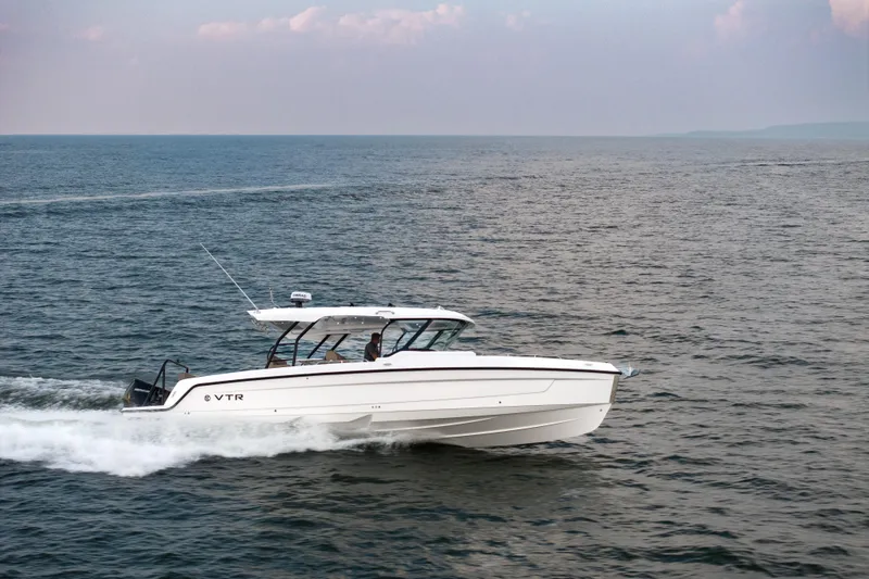 Slide: The Image of 2026 Cruisers Yachts 38 VTR boat displayed outdoors under a clear blue sky. - 2