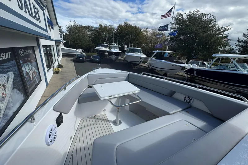 Slide: The Image of 2026 Cruisers Yachts 38 VTR on display at a boat dealership with other vessels. - 25
