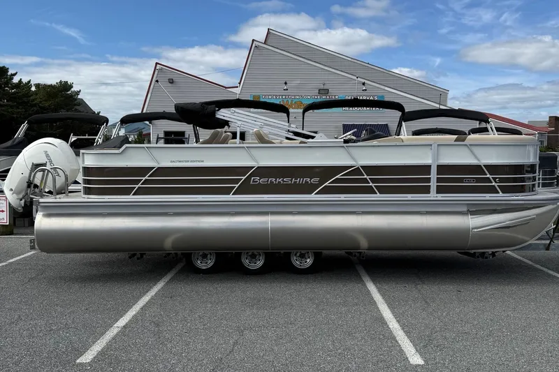 The Image of 2026 Berkshire 24RFC2 CTS 2.75 pontoon boat parked outdoors, side view. - 1