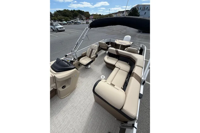 Slide: The Image of 2026 Berkshire 24RFC2 CTS 2.75 pontoon boat with beige seating and steering console. - 10