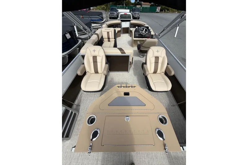 Slide: The Image of 2026 Berkshire 24RFC2 CTS 2.75 pontoon boat interior with beige seating and steering console. - 11