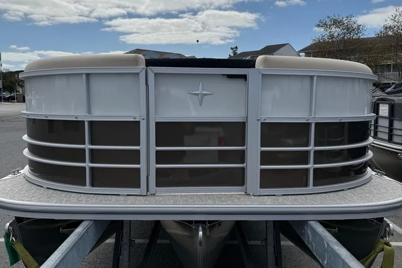 Slide: The Image of 2026 Berkshire 24RFC2 CTS 2.75 pontoon boat front view, parked on trailer. - 3