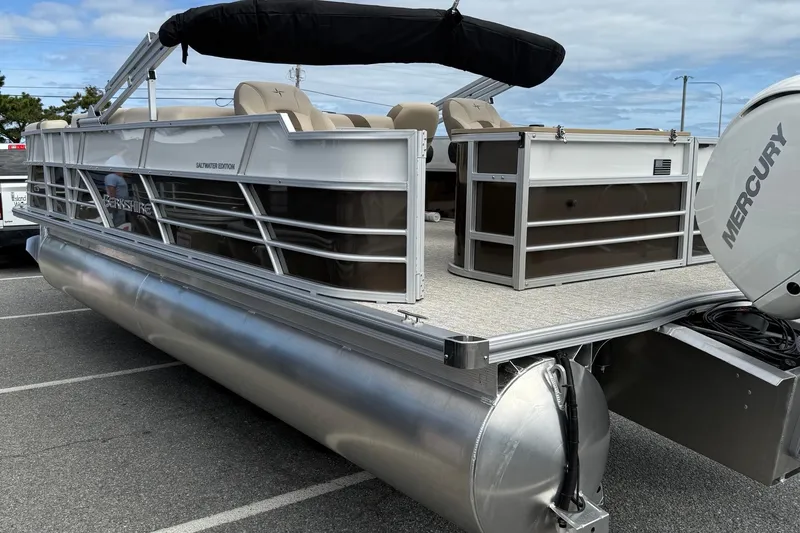 Slide: The Image of 2026 Berkshire 24RFC2 CTS 2.75 pontoon boat with Mercury engine, parked on asphalt. - 6