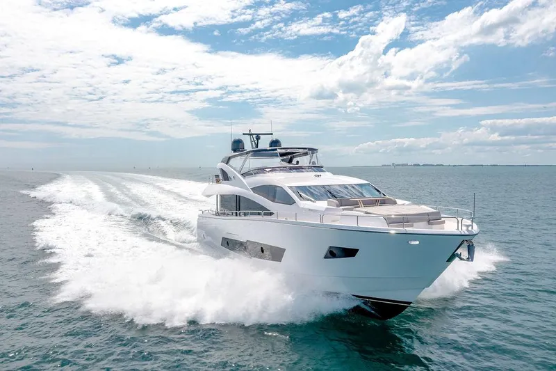 Slide: The Image of Luxurious 2021 Sunseeker 86 Yacht cruising on open water under a clear sky. - 3