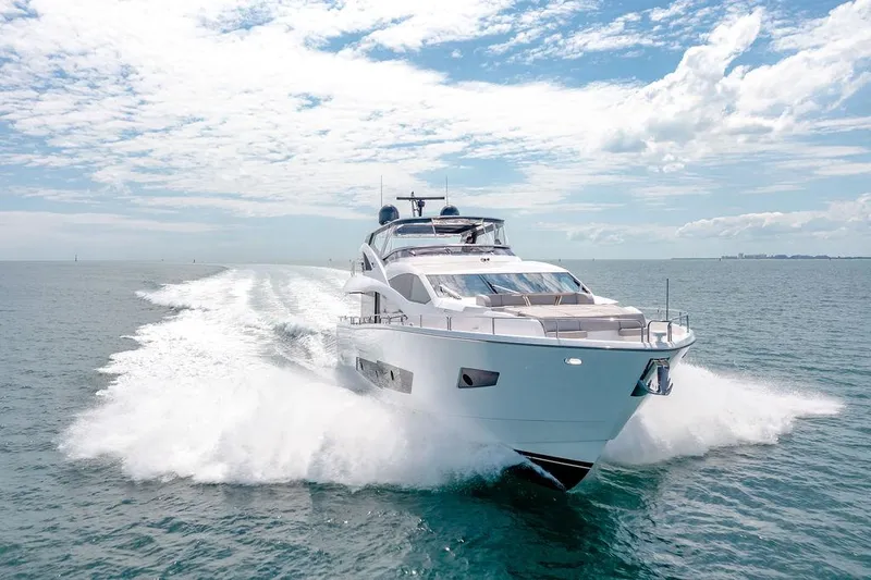 Slide: The Image of Luxurious 2021 Sunseeker 86 Yacht cruising on open water under a clear sky. - 4
