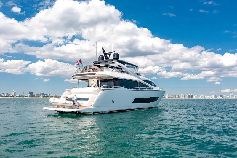 Slide: The Image of 2021 Sunseeker 86 Yacht on open water under blue sky and clouds. - 6