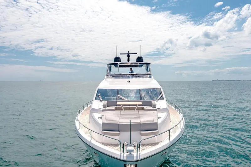 Slide: The Image of 2021 Sunseeker 86 Yacht on open sea under a partly cloudy sky. - 9