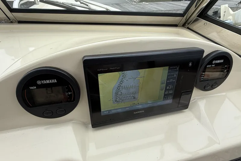 Slide: The Image of 2015 Rossiter 23 boat with Yamaha outboard motor docked on a sunny day. - 10