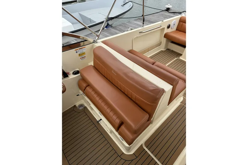 Slide: The Image of 2015 Rossiter 23 boat interior with steering controls and brown seating. - 16