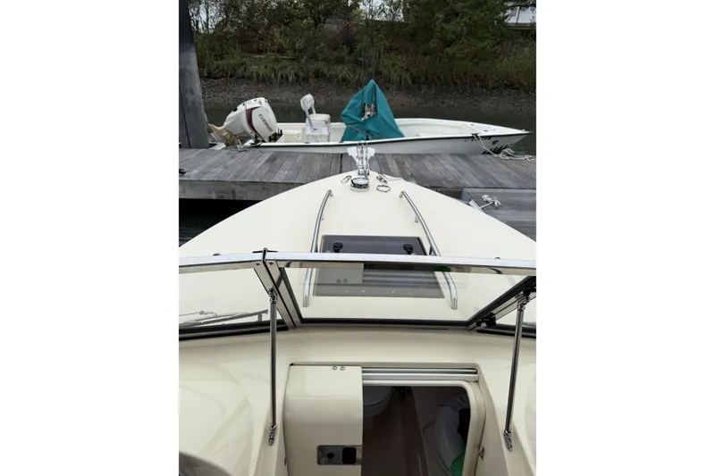Slide: The Image of 2015 Rossiter 23 boat interior with toilet, storage, and accessories. - 18