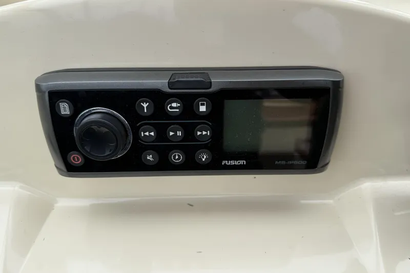 Slide: The Image of Steering console of a 2015 Rossiter 23 boat with wooden wheel and controls. - 8