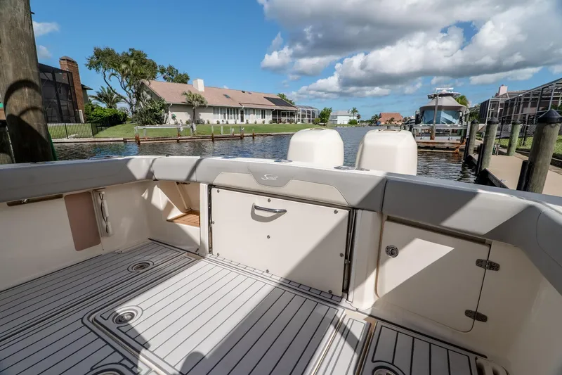 Slide: The Image of 2019 Scout 320 LXF boat interior with scenic waterfront view. - 10