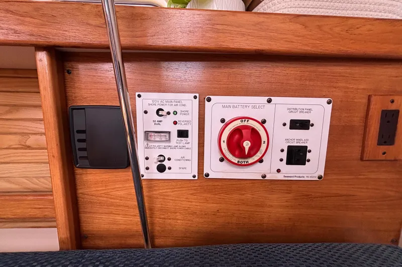 Slide: The Image of Control panel of a 2006 Catalina 320 sailboat with battery selector and circuit breakers. - 26