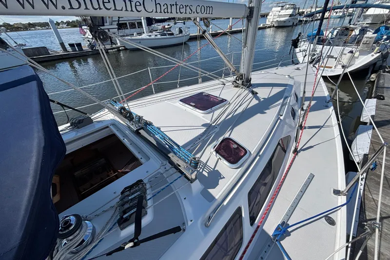 Slide: The Image of Catalina 320 sailboat, 2006 model, docked at marina with visible rigging and deck details. - 3