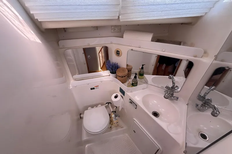 Slide: The Image of Compact bathroom in a 2006 Catalina 320 yacht with sink, toilet, and mirror. - 31