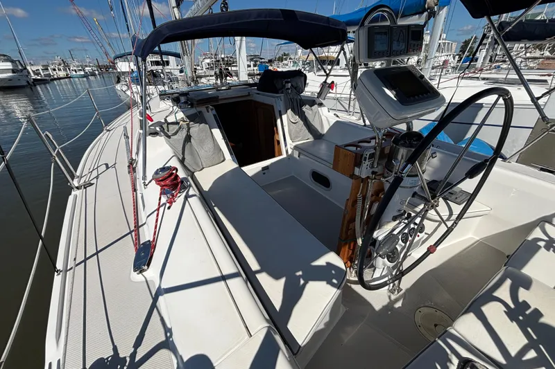 Slide: The Image of 2006 Catalina 320 sailboat cockpit with steering wheel and navigation equipment at marina. - 4
