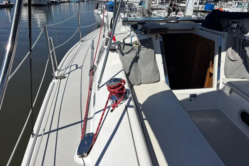 Slide: The Image of 2006 Catalina 320 sailboat deck with winch and open cabin entrance. - 5