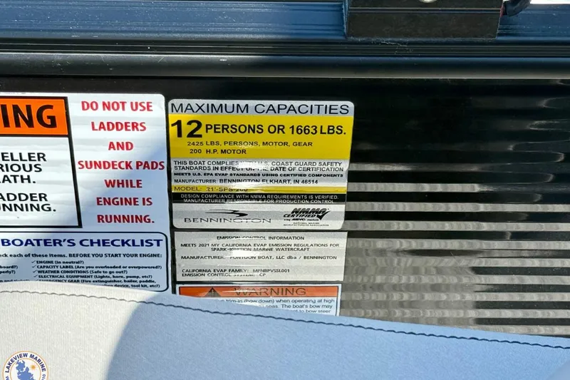 Slide: The Image of Warning label on 2021 Bennington 22 LSB boat showing maximum capacity and safety instructions. - 13