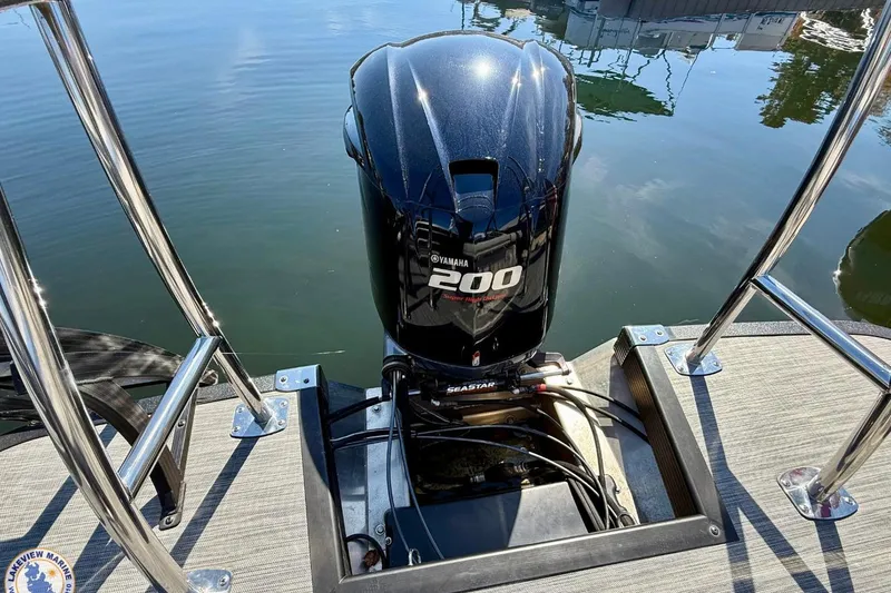 Slide: The Image of 2021 Bennington 22 LSB with Yamaha 200 engine on calm water. - 2