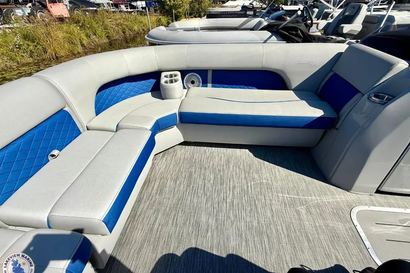 Slide: The Image of 2021 Bennington 22 LSB pontoon boat interior with blue and gray seating. - 5