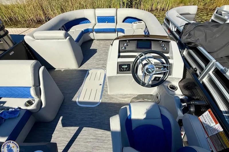 Slide: The Image of 2021 Bennington 22 LSB pontoon boat interior with plush seating and modern helm. - 6