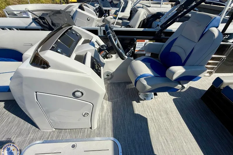 Slide: The Image of 2021 Bennington 22 LSB boat interior with captain's chair and control console. - 7