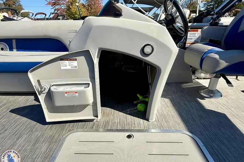 Slide: The Image of 2021 Bennington 22 LSB boat interior with open storage compartment and seating. - 8