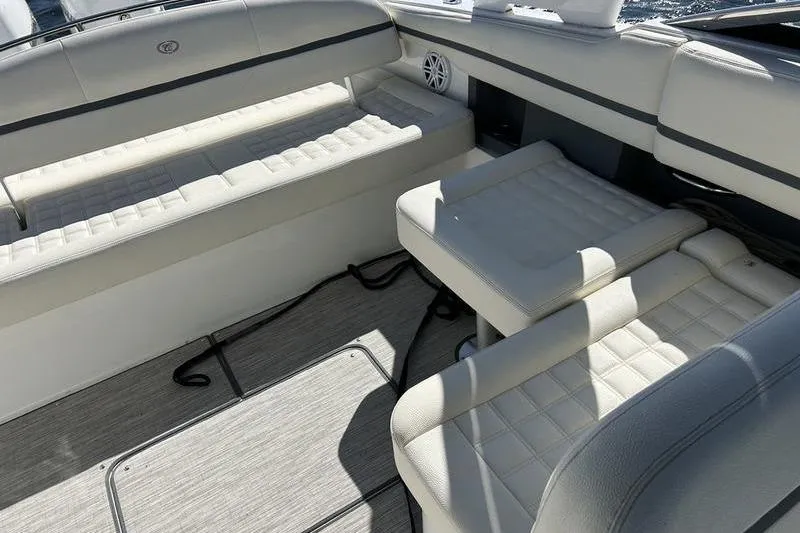 Slide: The Image of 2022 Cobalt 30SC Outboard boat interior with white cushioned seating and speaker. - 11