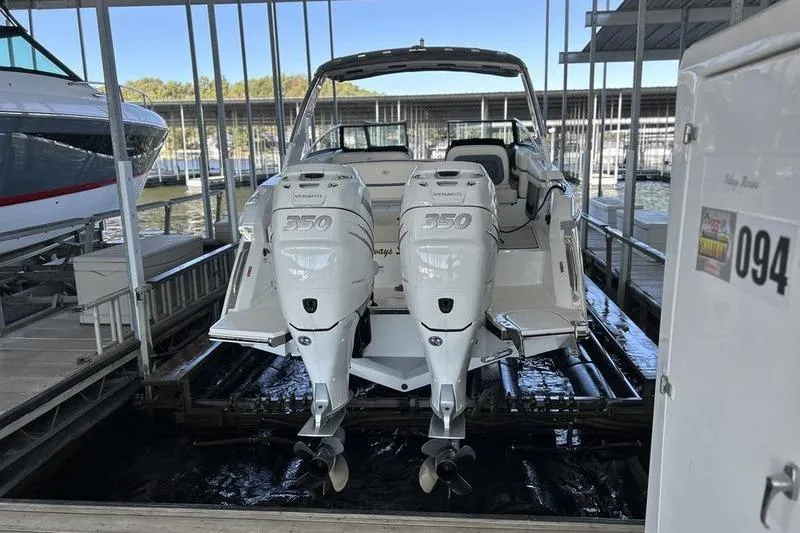 Slide: The Image of 2022 Cobalt 30SC Outboard with twin engines docked in a marina. - 14